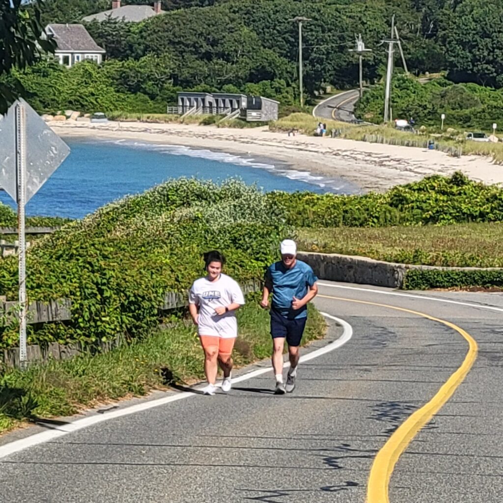Delanie Corcoran and Colin Corcoran running on Nobska Road, as they train for the Falmouth Road Race.